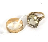 Two 9ct gold rings. Comprising a wedding band, size O, 3.8g and a citrine dress ring, size N, 6.