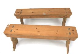 A pair of small pine pews.