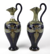 A pair of Royal Doulton stoneware pouring ewers.