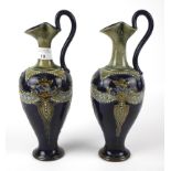 A pair of Royal Doulton stoneware pouring ewers.