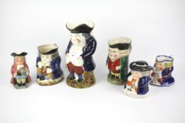 A group of 19th century/early 20th century Staffordshire pottery Toby jugs.
