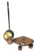 An early 19th century copper and brass mounted bed warming pan and other items of copper.
