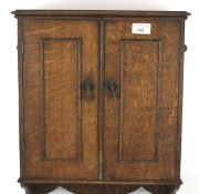 An early 20th century oak wall mounting cabinet.