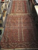 Two 19th century Eastern floor rugs. One with central medallions on a red ground (92cm x 185cm).