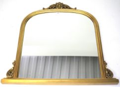 A contemporary gilt framed oval mantel mirror.