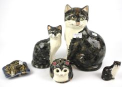 Five ceramic models of cats in various poses. Various sizes, largest H30.