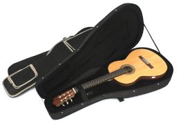 A Yamaha CG-101MS acoustic guitar.