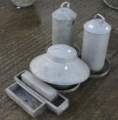 Assorted galvanized chicken feeders and related items.