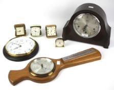 An assortment of clocks, barometers and travel clocks.