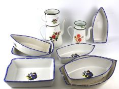 An assortment of continental ceramic dishes and two enamel coffee pots.
