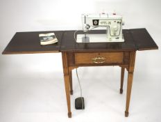 An oak cased Singer electric sewing machine.