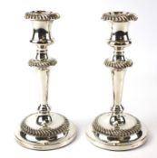 A pair of contemporary Mappin & Webb silver plated candlesticks.