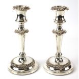 A pair of contemporary Mappin & Webb silver plated candlesticks.