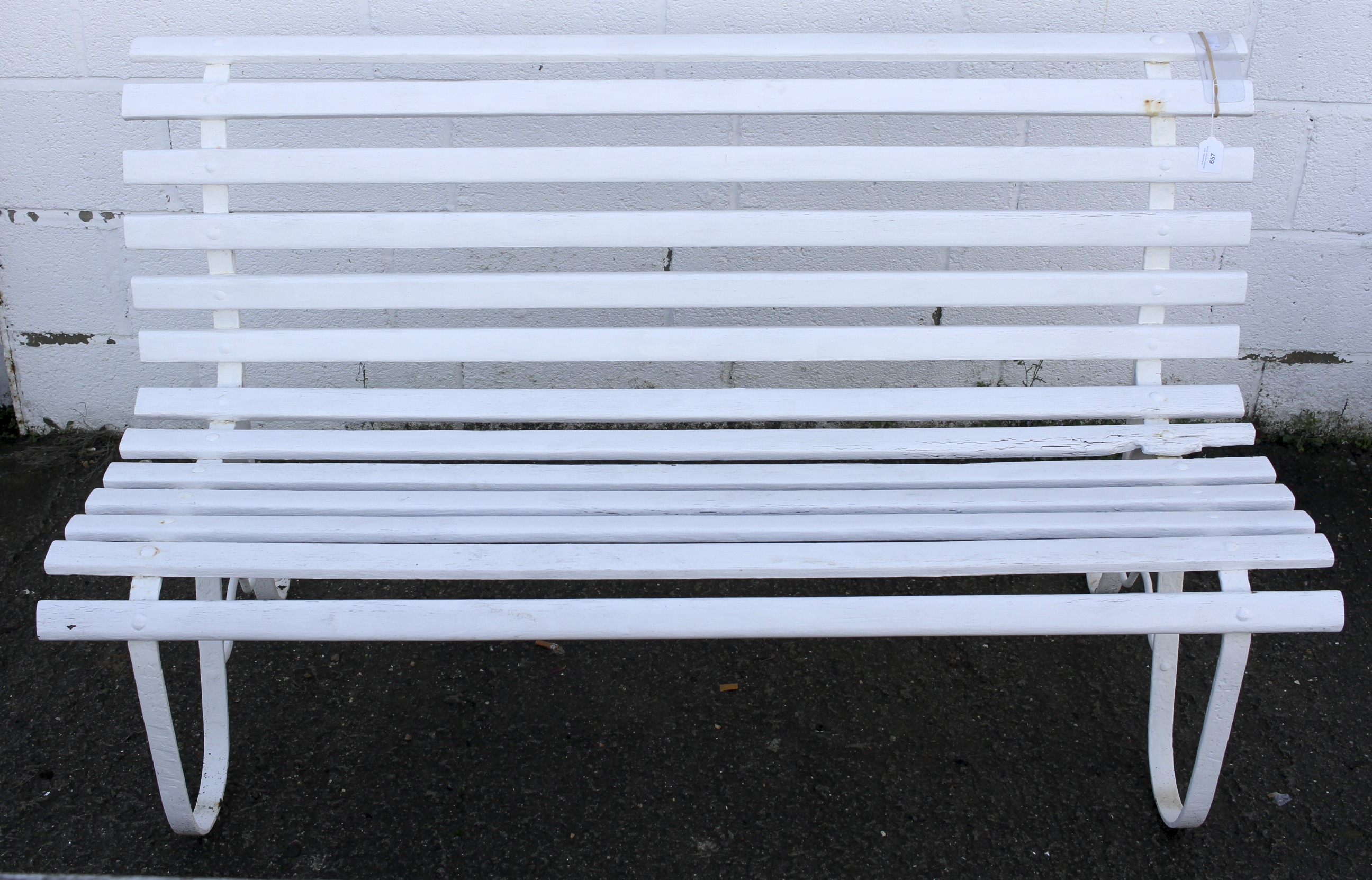 A white painted garden bench.