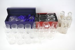 An assortment of drinking glassware. Including decanters, some boxed.