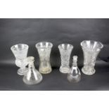 A collection of cut glass vases and decanters.