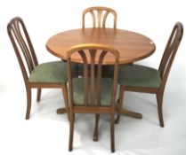 A contemporary extendable wooden table and four chairs.