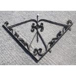 A vintage black painted metal shop sign bracket.