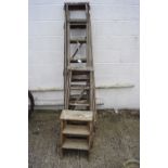 An assortment of vintage wooden ladders.