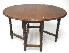 A 1930s oak oval toped gateleg table.