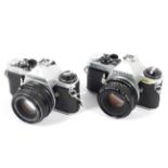 Two Pentax 35mm SLR cameras.
