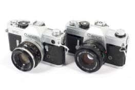 Two Canon 35mm SLR cameras. To include an FX with a 50mm 1:1.