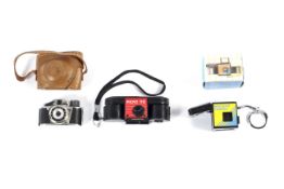 Three sub-miniature film cameras.