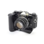 An Olympus OM-2N 35mm SLR camera. Black, with a 50mm 1:1.4 G.