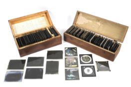 Two fitted wooden boxes containing an assortment of glass slides.