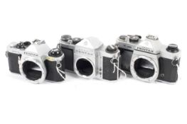 Three Pentax 35mm SLR camera bodies.
