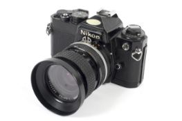 A black Nikon FE 35mm SLR camera. With a 35-70mm 1:3.3-4.