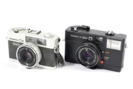 Two Konica 35mm compact cameras.