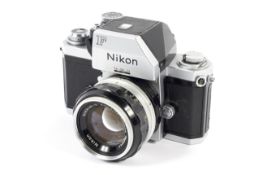 A silver Nikon F 35mm SLR camera. With Photomic FTN finder and 50mm 1:1.
