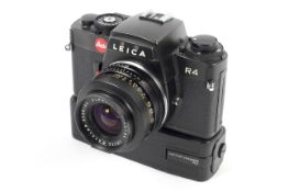 A black Leica R4 35mm SLR camera. With a 35mm 1:2.