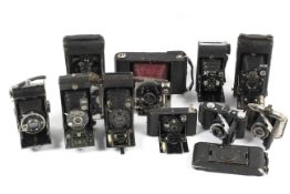 A collection of antique folding cameras.