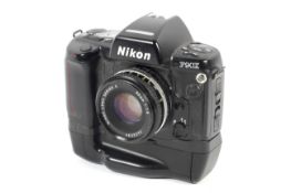 A Nikon F90X 35mm SLR camera. With MB-10 battery grip and a 50mm 1:1.