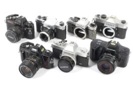 Seven 35mm SLR cameras. To include an Olympus FTL with a 50mm 1:1.