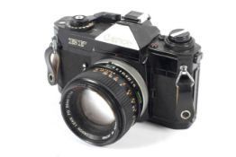 A Canon EF 35mm SLR camera with a 50mm 1:1.4 lens.