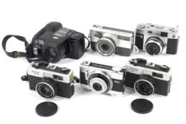 Six Ricoh 35mm cameras.