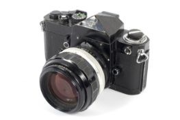 A black Nikon F 35mm SLR eye level camera. With an 85mm 1:1.8 Nikkor-H.