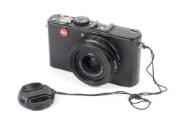 A black Leica D-Lux 4 digital point and shoot camera.