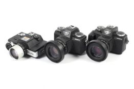 Three Minolta 110 SLR cameras.