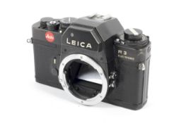 A black Leica R3 electronic 35mm SLR camera body.