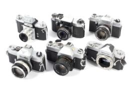 Six 35mm SLR cameras.