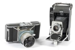 Two instant cameras. To include a Polaroid Pathfinder 120 folding camera with a 127mm 1:4.