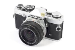 An Olympus OM-2N 35mm SLR camera with a 21mm 1:3.