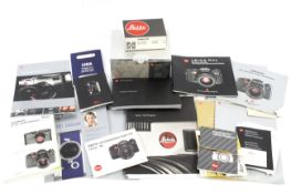Two Leica Trinovid binocular boxes and various Leica brochures and booklets.