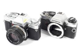 Two Olympus 35mm cameras. To include an OM10 body and an OM30 with a 50mm 1:1.