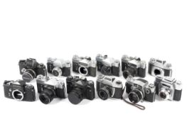 Twelve 35mm SLR cameras.