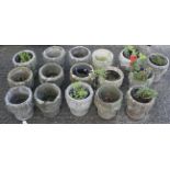A collection of sixteen composite stone garden pots.